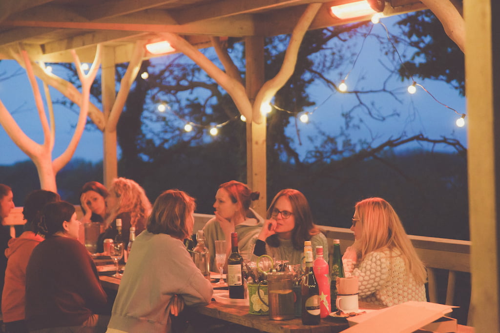people talking at an outdoor patio dinner