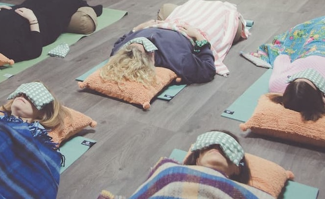 group of business-owners in a guided meditation